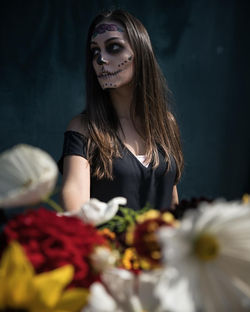 Midsection of woman with flower bouquet