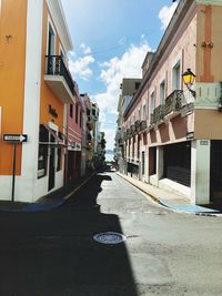 Street amidst buildings in city against sky