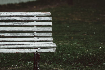 Close-up of empty bench on field