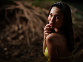 Portraiture shot of a beautiful asian female model in bikini at a river