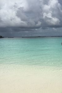 View of calm sea against cloudy sky