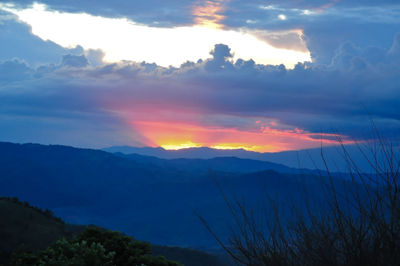 Scenic view of mountains against dramatic sky