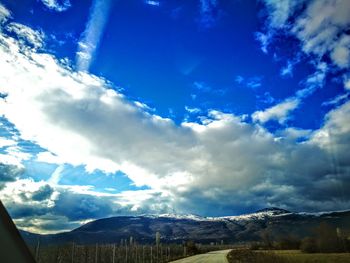 Scenic view of landscape against blue sky