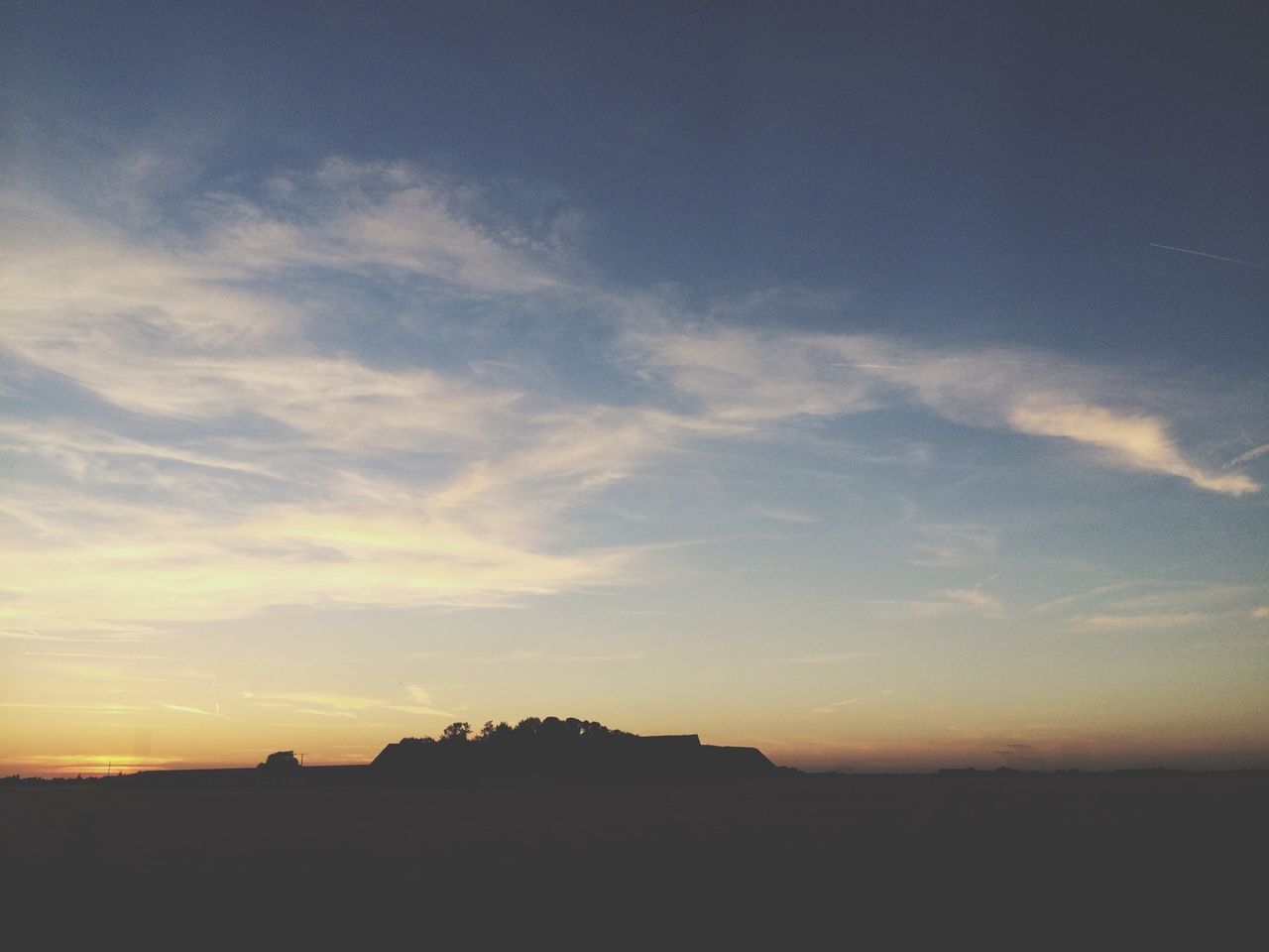 sunset, silhouette, sky, building exterior, built structure, architecture, scenics, beauty in nature, tranquil scene, cloud - sky, tranquility, orange color, nature, cloud, landscape, outdoors, idyllic, no people, sunlight, copy space