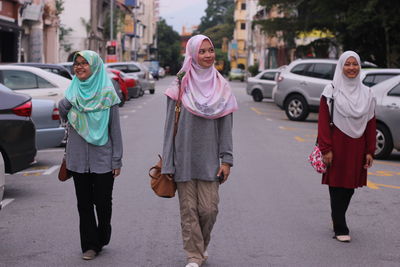 View of people walking on street in city