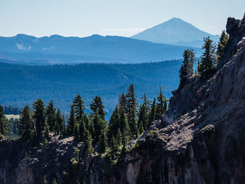 Scenic view of a rocky ridge against sky with multiple layers of different mountains in the back