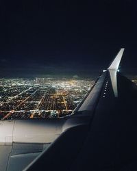 Aerial view of illuminated city against sky at night