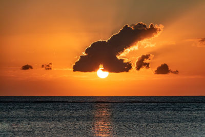 Scenic view of sea against orange sky