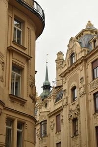 Low angle view of statue in city against sky