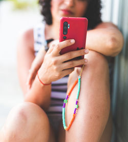 Midsection of woman using mobile phone