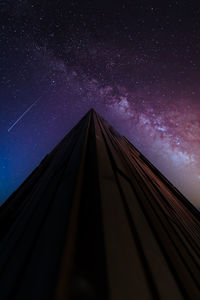 Low angle view of skyscraper against sky at night