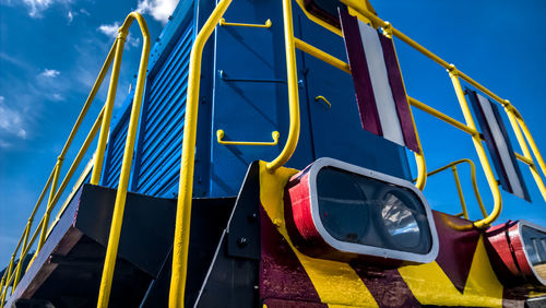 Low angle view of multi colored wall against blue sky