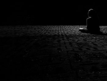 Woman sitting in the dark
