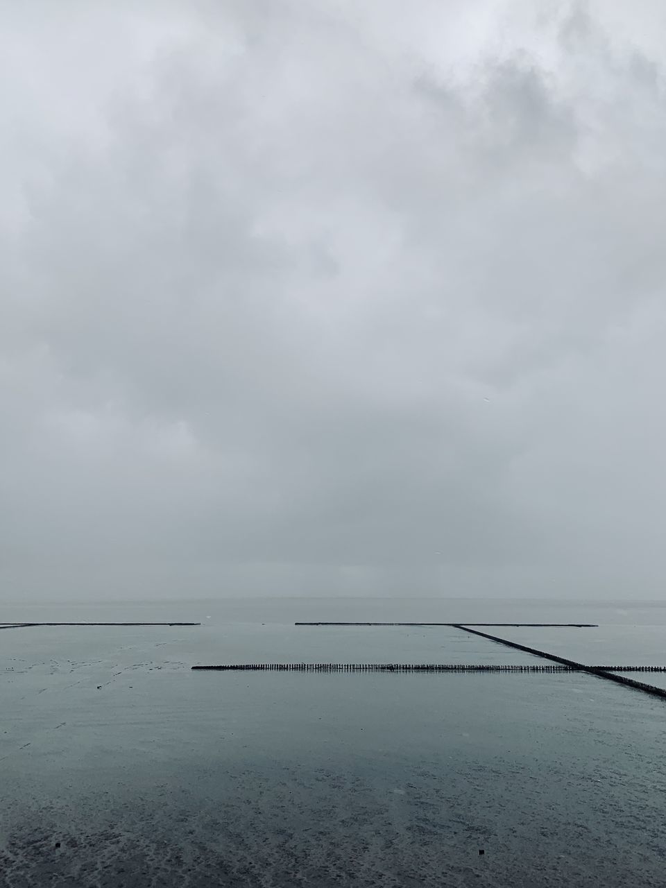 SCENIC VIEW OF SHORE AGAINST SKY