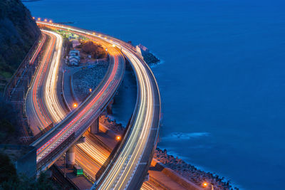 High angle view of light trails on road at night