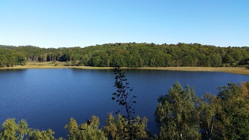 Scenic view of lake against clear blue sky