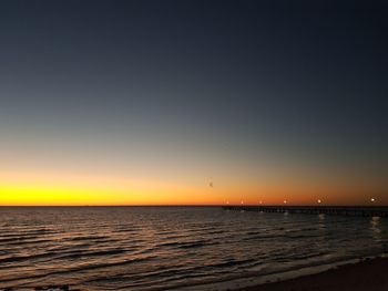 Scenic view of sea against clear sky during sunset