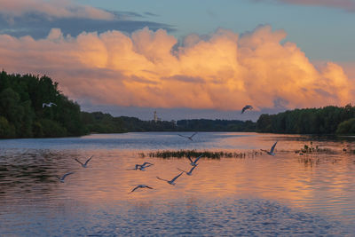 Scenic view of lake against sky during sunset