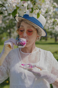 Portrait of young woman holding ice cream cone