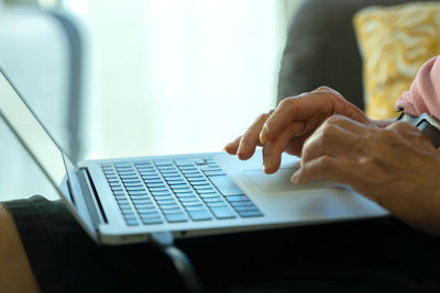 Midsection of woman using mobile phone