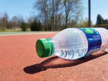 Close-up of water bottle left on a basketball court in the summer