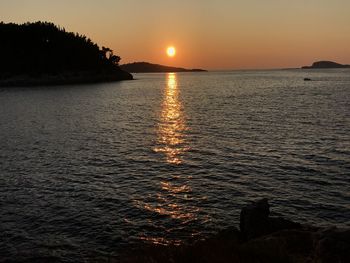 Scenic view of sea against clear sky during sunset