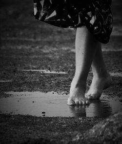 Low section of woman walking at beach