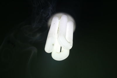 Close-up of light bulb against black background