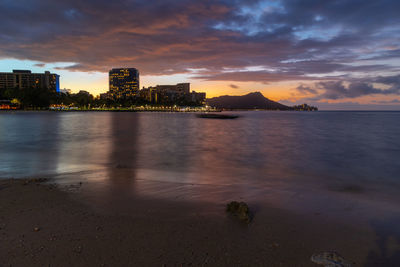 Sunrise over waikiki beach with an outrigger