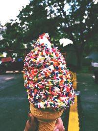 Close-up of hand holding ice cream cone