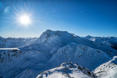 Scenic view of snowcapped mountains against sky