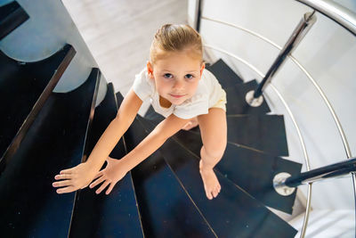 High angle view of boy standing on escalator