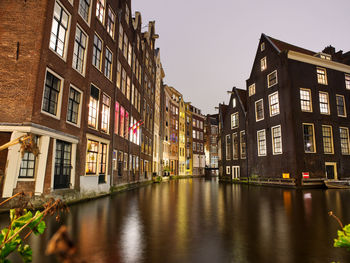 Canal amidst buildings in city