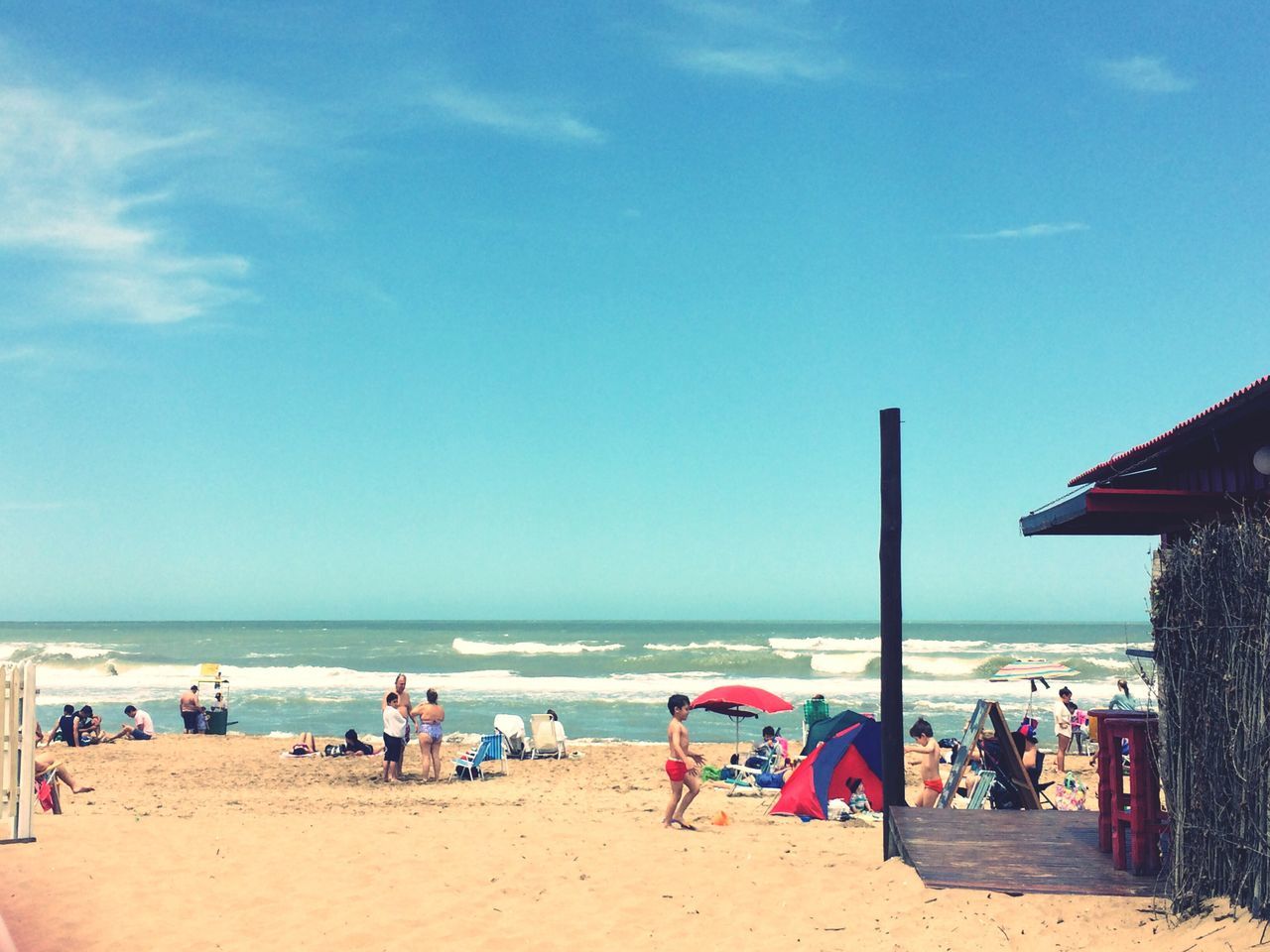 beach, sea, sand, horizon over water, shore, large group of people, vacations, water, beach umbrella, leisure activity, relaxation, summer, sky, parasol, lifestyles, person, scenics, mixed age range, enjoyment