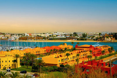 High angle view of buildings by sea against sky