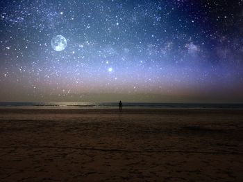 Scenic view of beach against sky at night