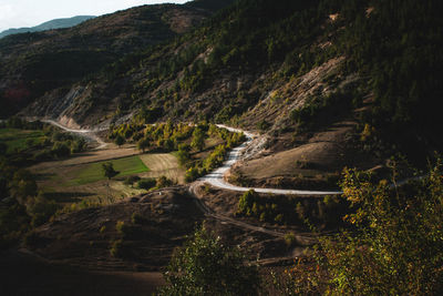 High angle view of road amidst trees against sky