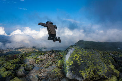 Woman jumping in mountains