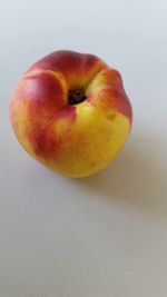 Close-up of red fruit over white background