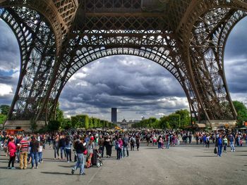 Tourists against cloudy sky