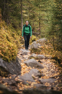 Man walking on footpath in forest