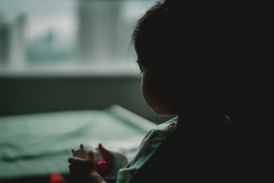 Close-up portrait of a boy looking at home