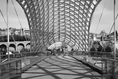 Bridge in city against sky