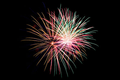 Low angle view of firework display at night