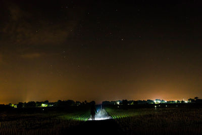 Scenic view of field against sky at night