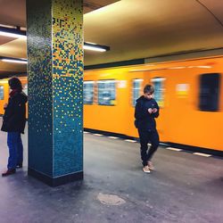 Full length of woman standing by railing