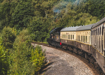 Train on railroad track by mountain