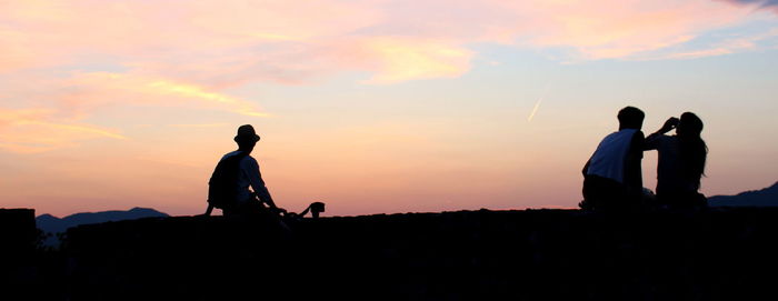 Silhouette of people at sunset