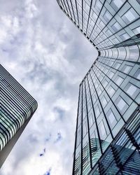 Low angle view of modern building against cloudy sky