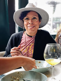 Portrait of a smiling young woman having brunch